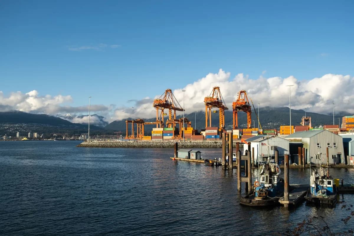 Cargo cranes and stacked shipping containers at a container port
