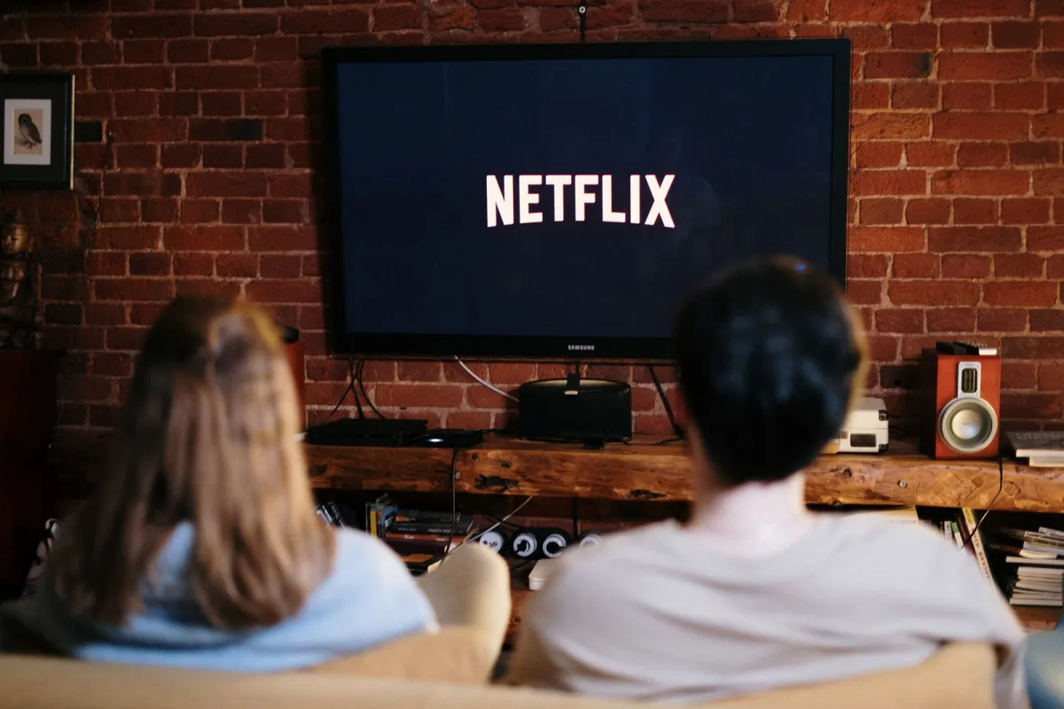 A couple watching Netflix on the couch in a cozy living room in December
