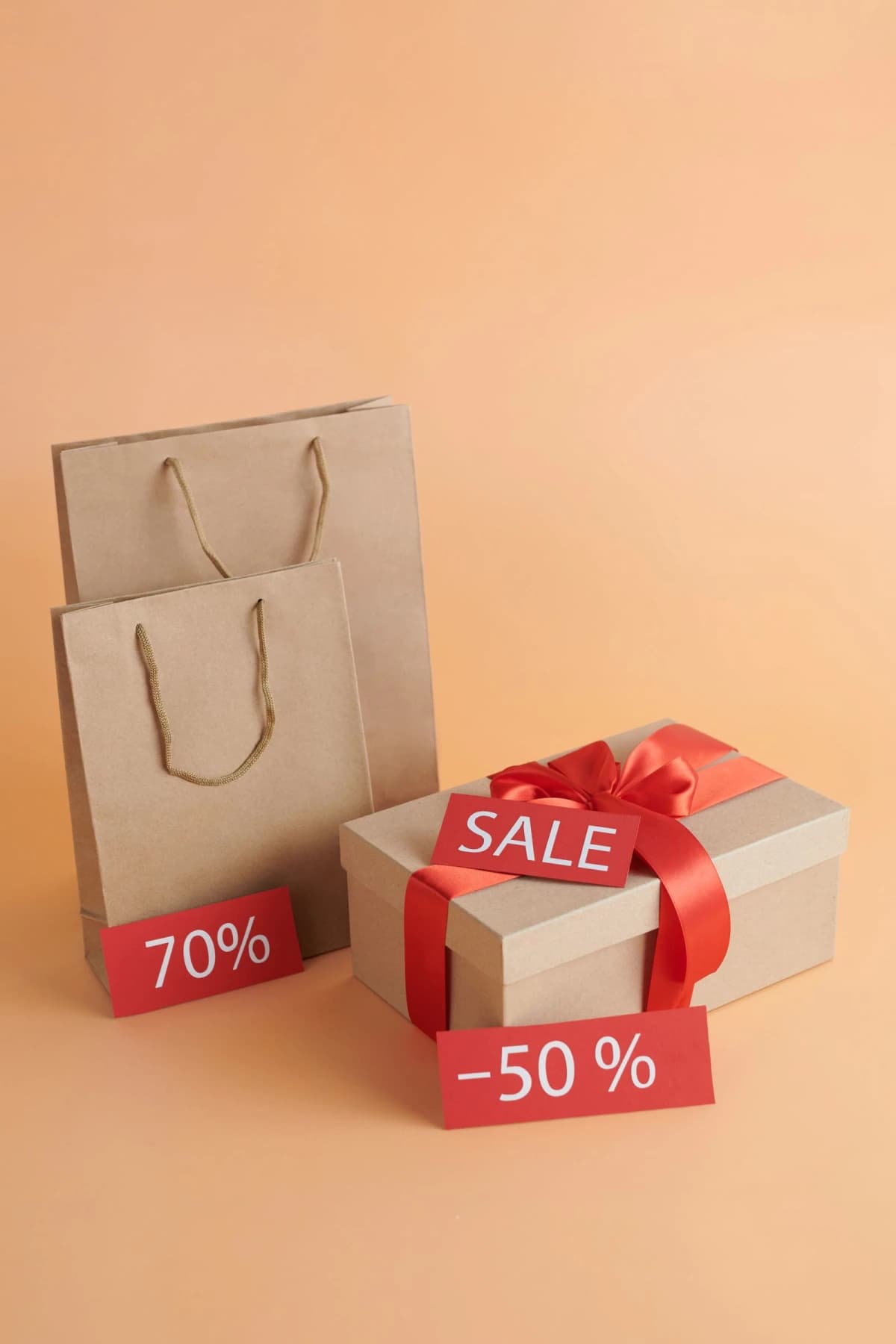 Shopping bags and a sale sign among holiday gift boxes in a festive retail scene
