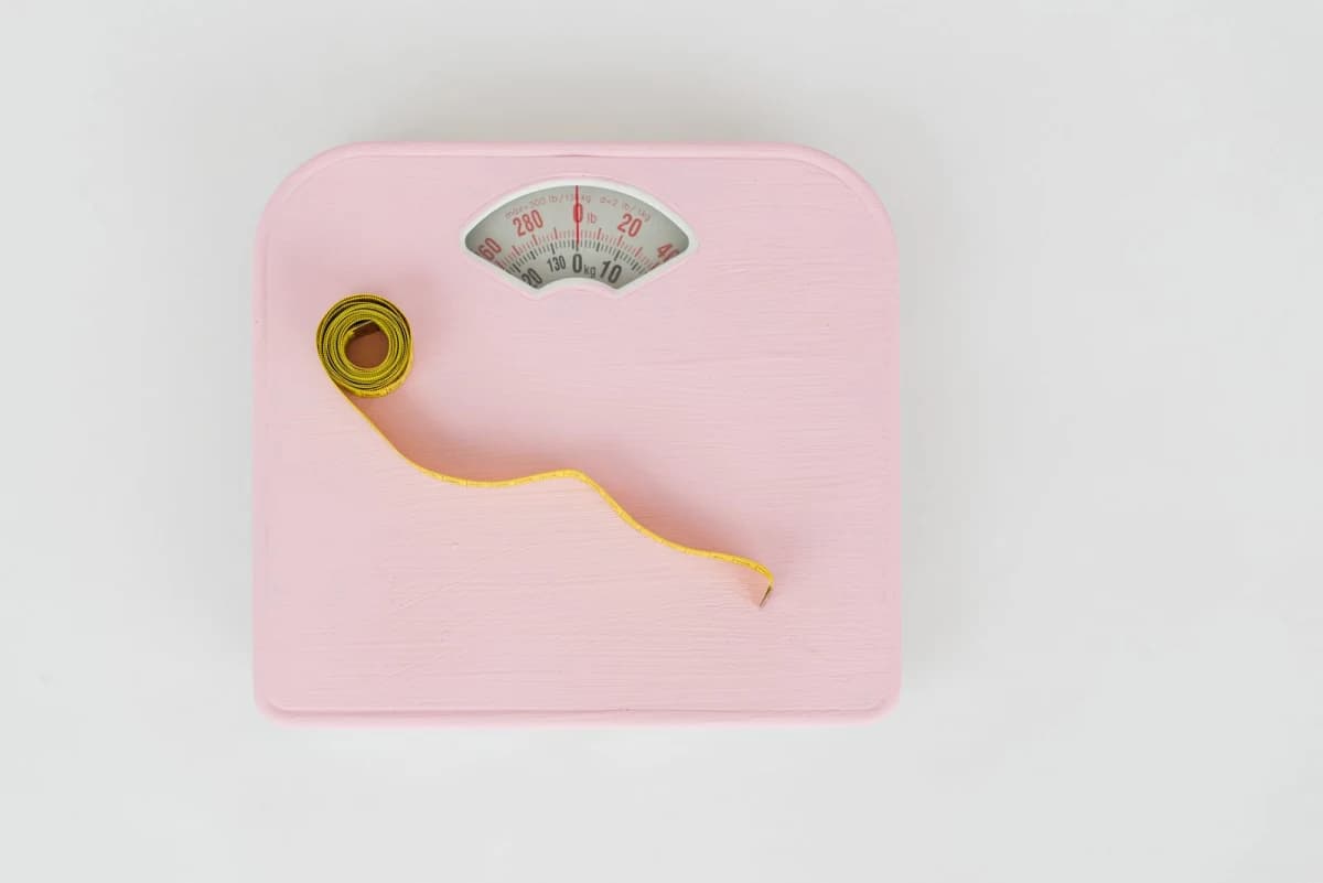 A measuring tape resting on a weighing scale, symbolizing weight management after stopping GLP-1 drugs