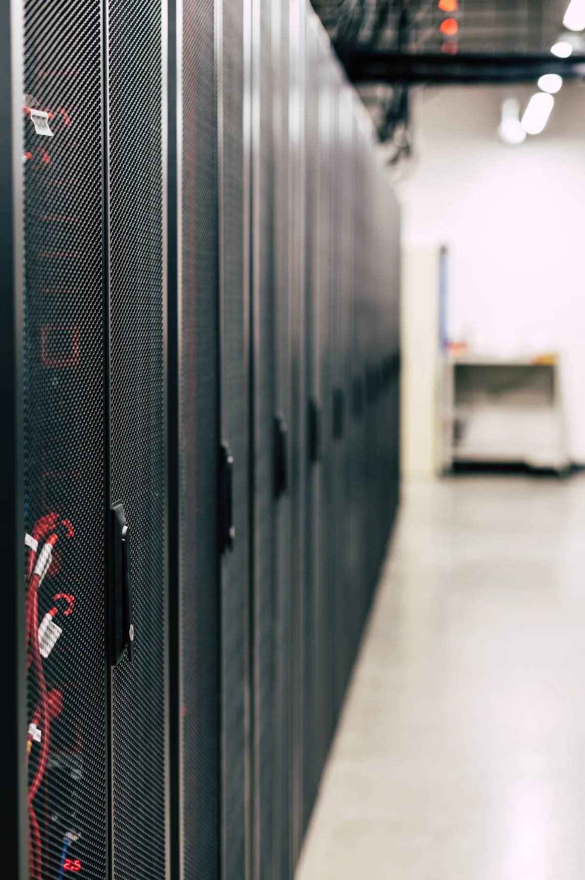 Interior of a hyperscale AI data center with rows of illuminated server racks