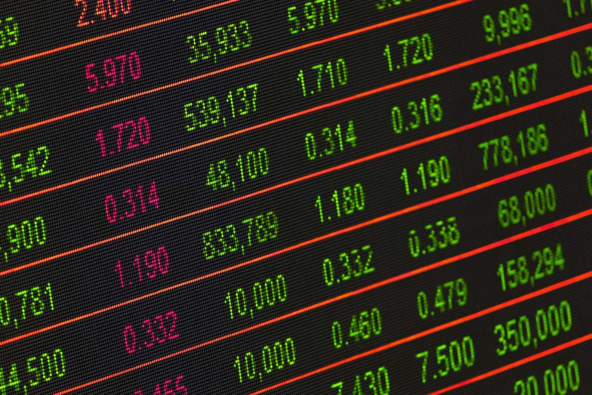 Close-up of a stock market ticker board with red and green figures, evoking Nortel's rise and fall