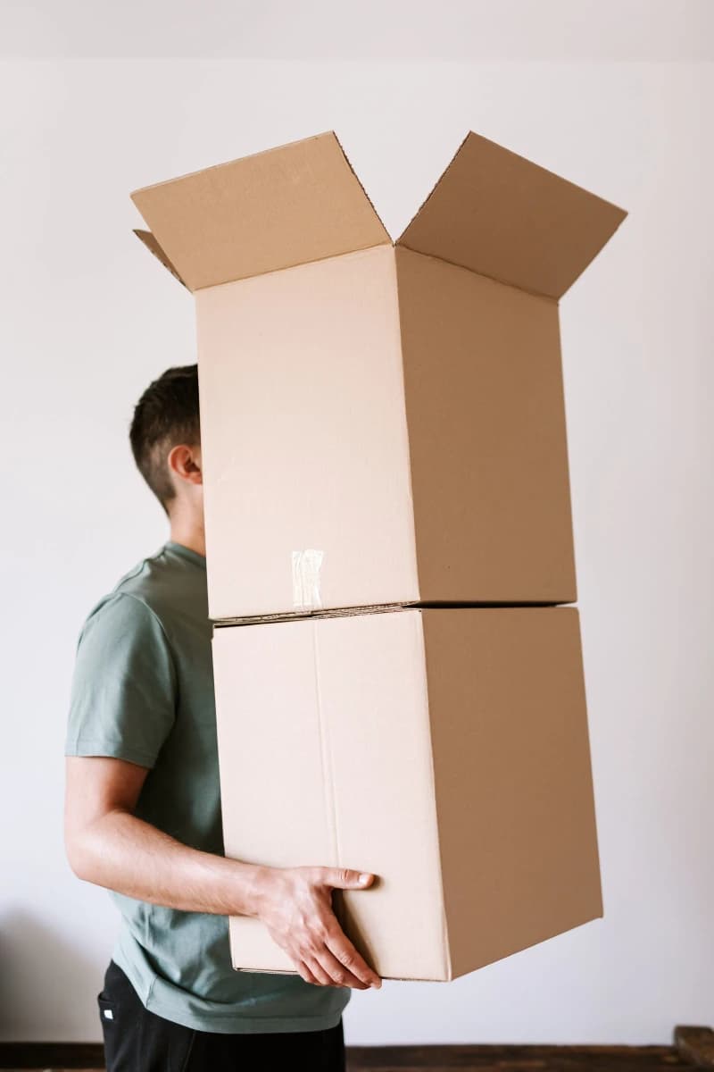 Amazon parcels and a smartphone with a shopping app on a kitchen table in morning light