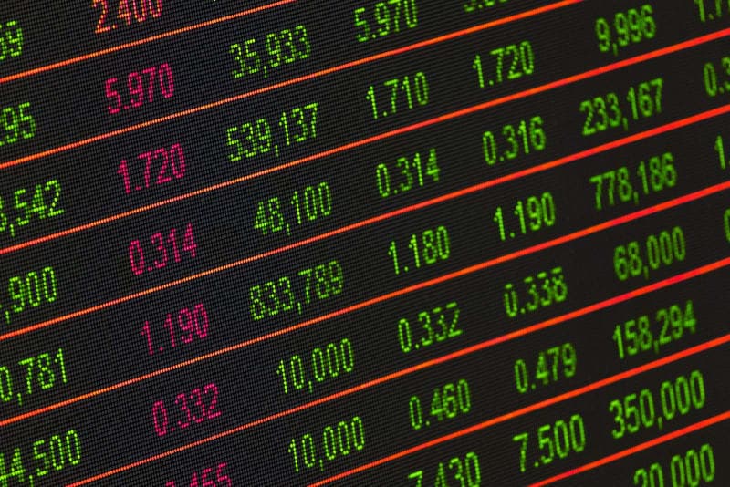 Close-up of a stock market ticker board with red and green figures, evoking Nortel's rise and fall